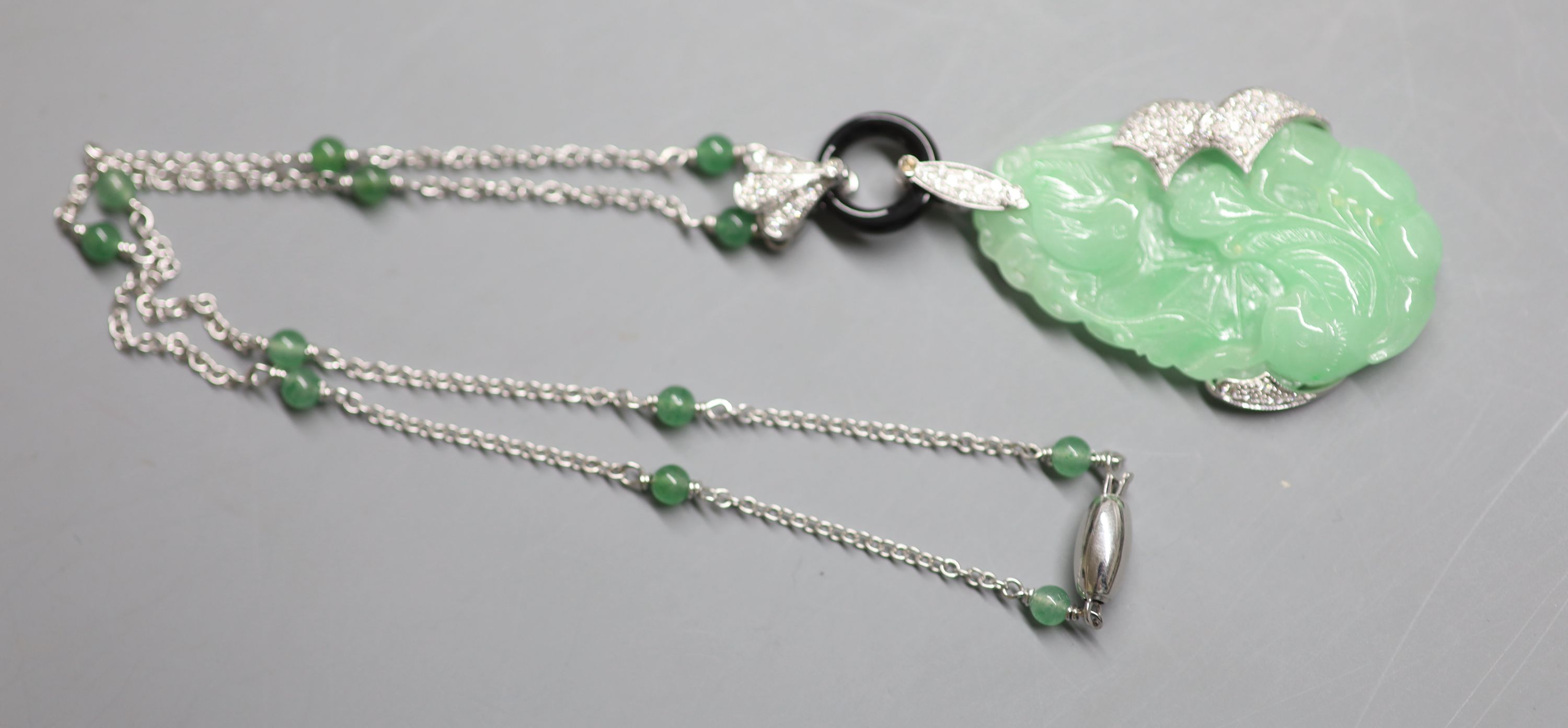 A modern Italian 750 white metal, jadeite, black onyx and diamond set pendant necklace,